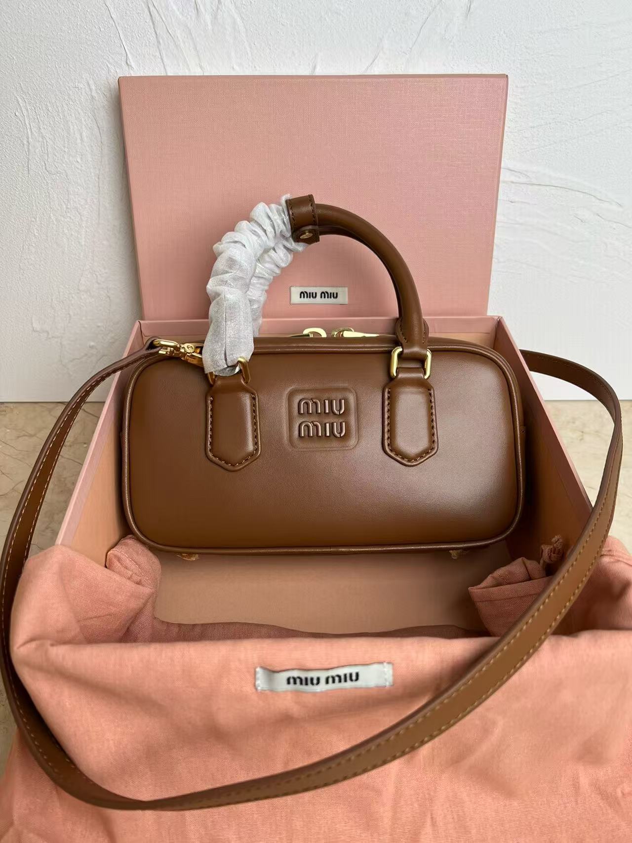 Miu Miu Embossed Logo Barrel Handbag